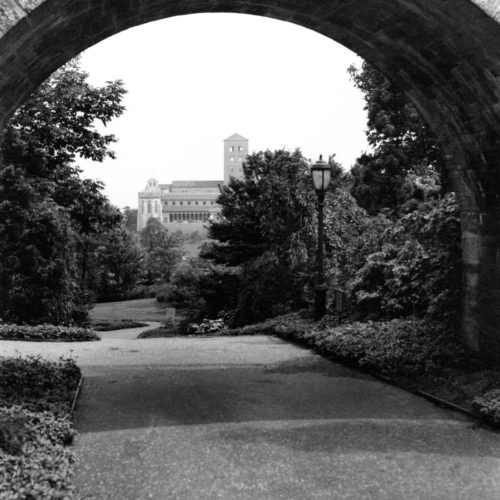 Walk way under a brick bridge at the Met Cloisters.