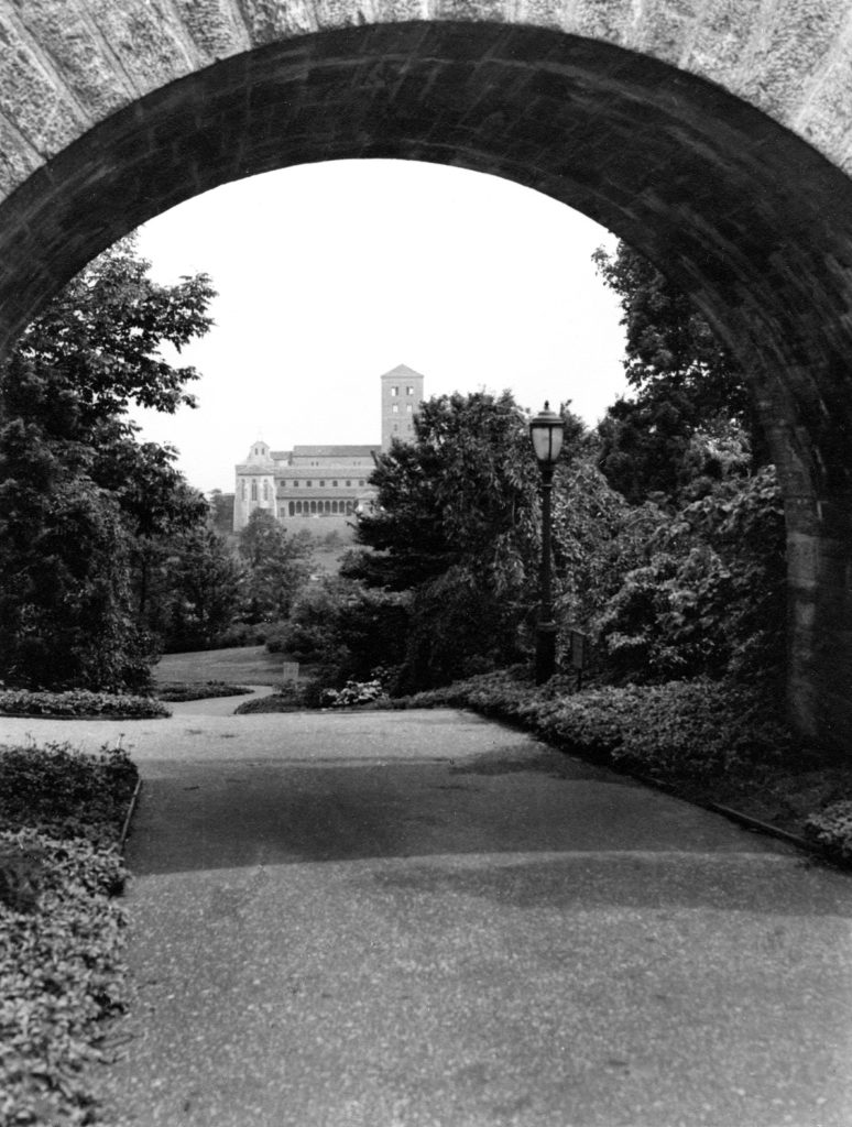 Walk way under a brick bridge at the Met Cloisters.