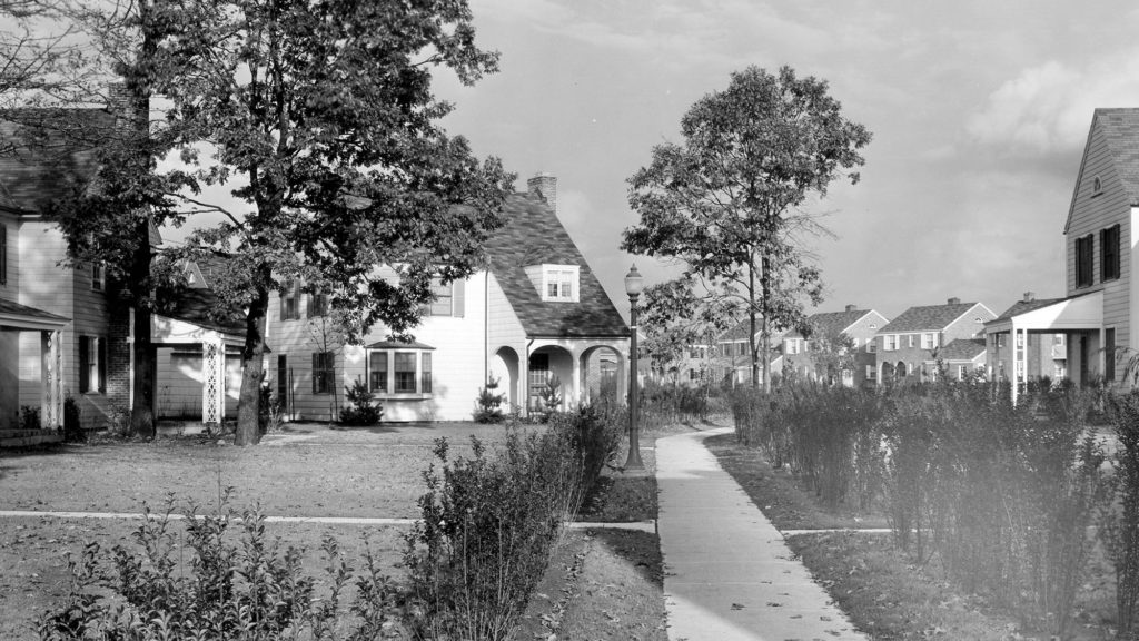 Black and white photo of Radburn, New Jersey. Featured are houses within the community with walkways lined with shrubs.